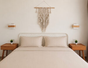 Double bed beneath a macrame wall hanging with wooden bedside tables.