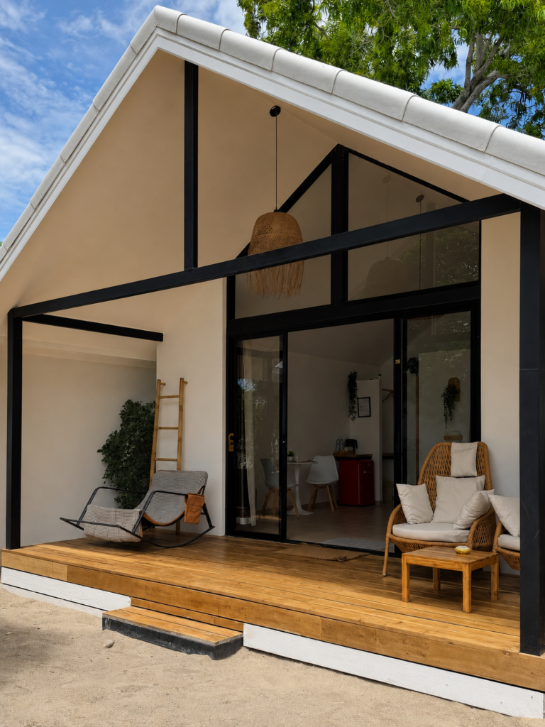 Full villa facade with a pitched roof, tall glass doors and wooden terrace.