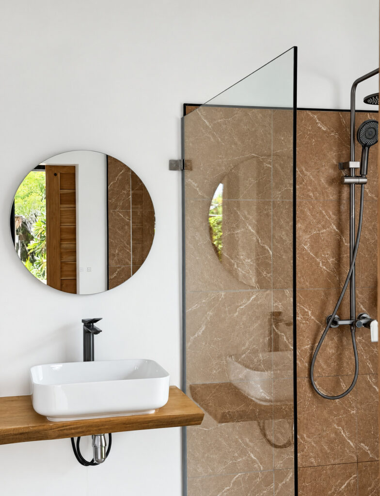 Countertop basin and shower with a glass screen and overhead showerhead.