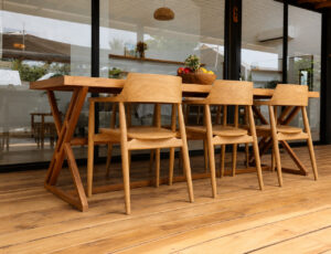 Large wooden dining table and chairs beside the terrace glass doors.