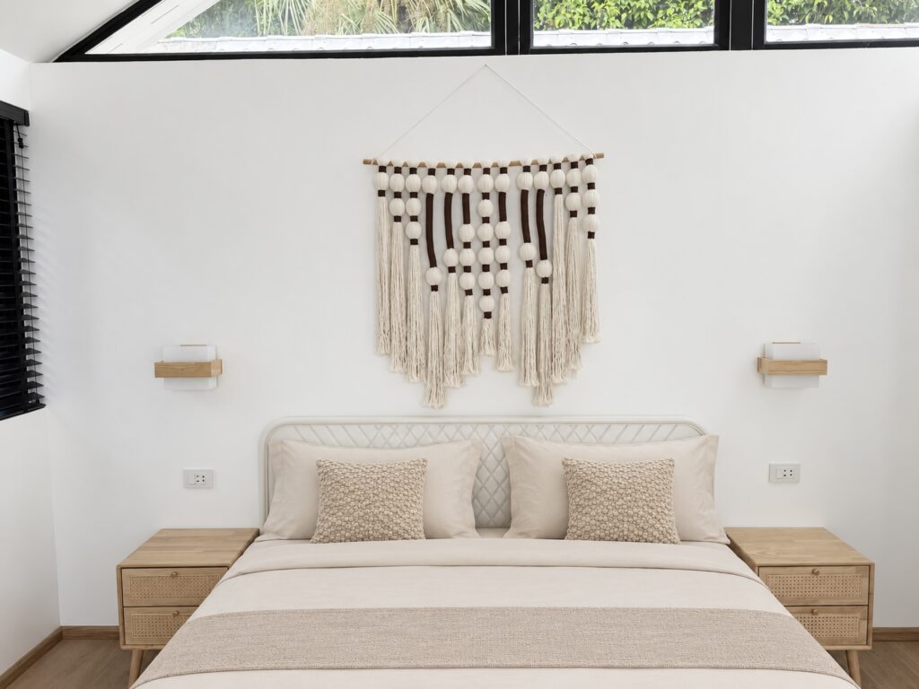 Double bed with textured cushions and wooden bedside tables.