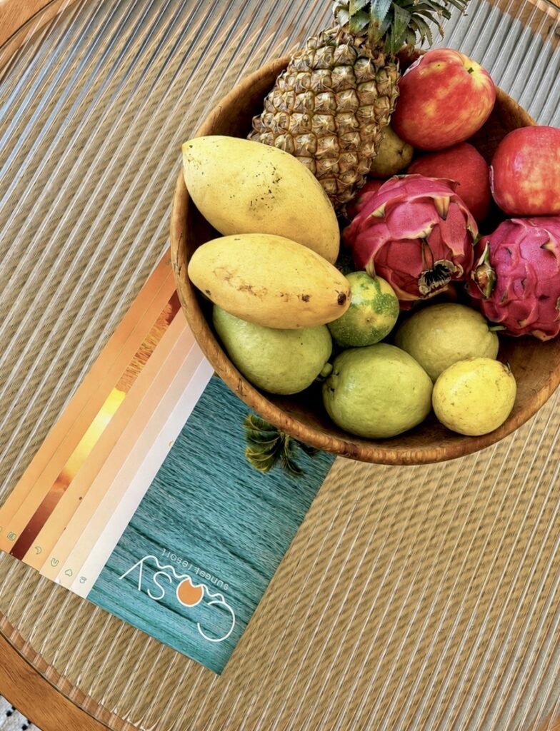 Bowl of fruit on the woven coffee table.