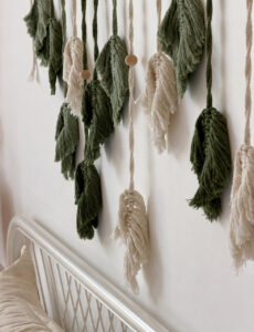 Close view of the woven leaf wall hanging above the bed.