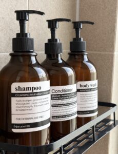 Shampoo, conditioner and body wash dispensers in the shower.