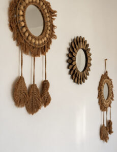 Decorative woven-framed mirrors with hanging woven details.